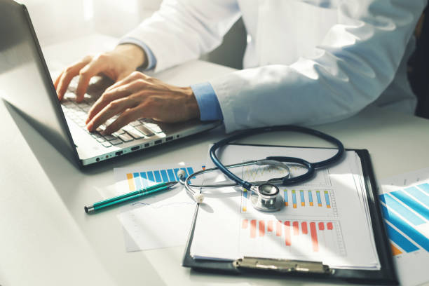 doctor working with medical statistics and financial reports in office as his part of healthcare